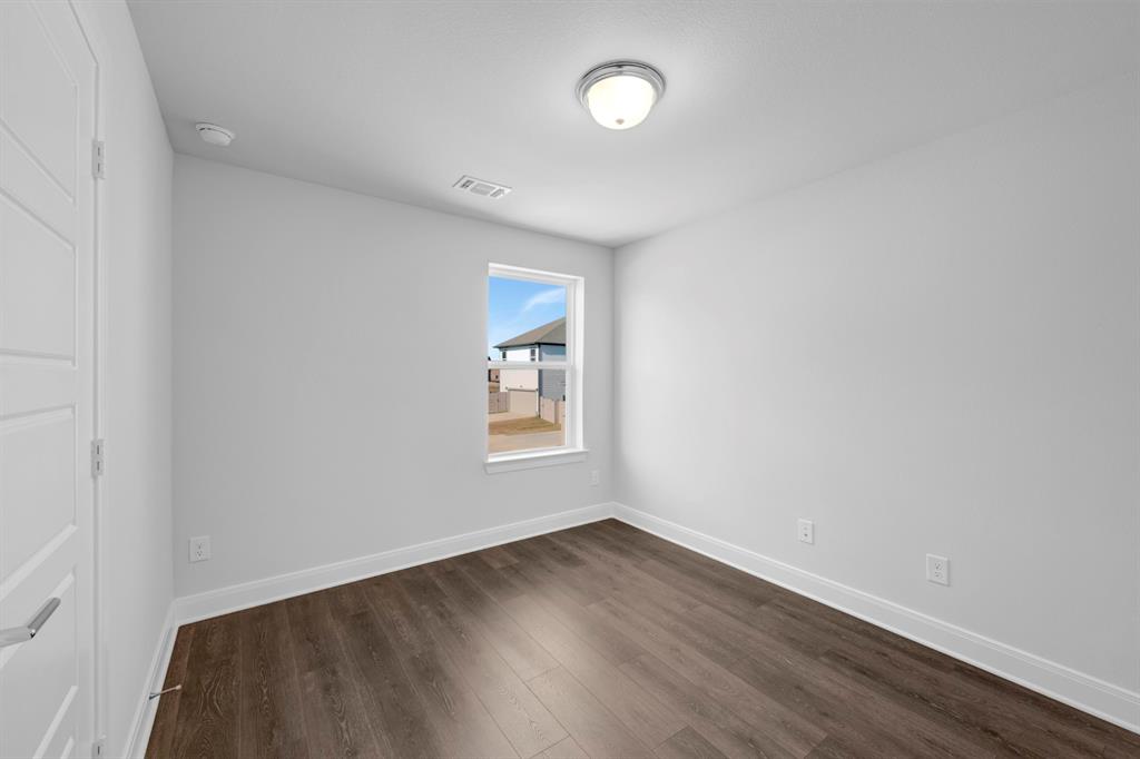 3501 Pineda Way McKinney, TX 75071 - Photo 32 of 40 an empty room with wooden floor and windows