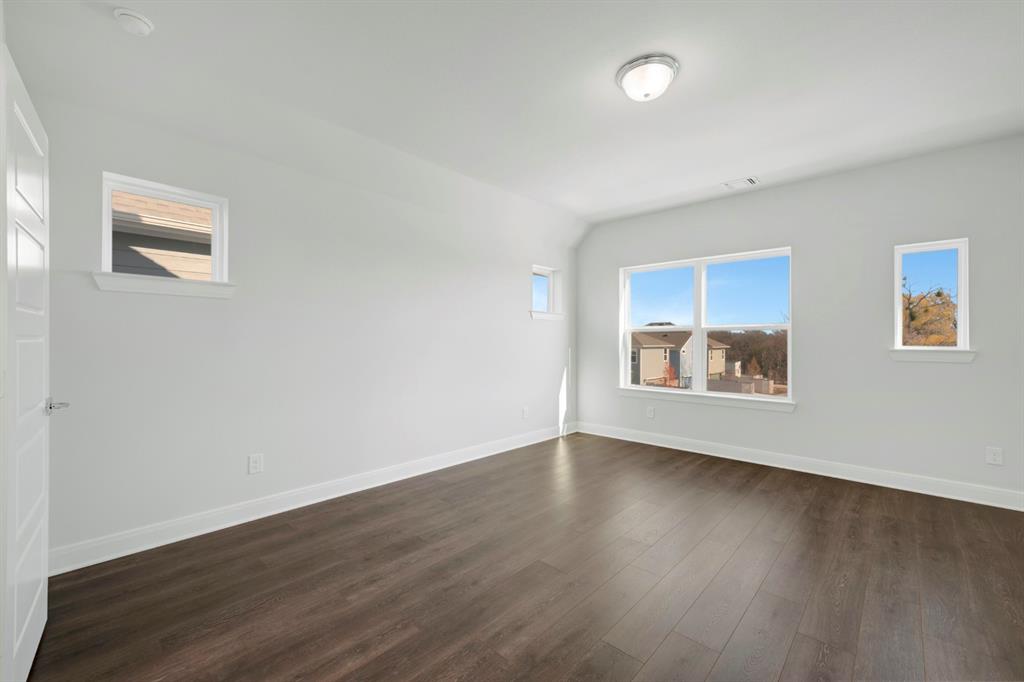 3501 Pineda Way McKinney, TX 75071 - Photo 36 of 40 a view of an empty room with wooden floor and a window