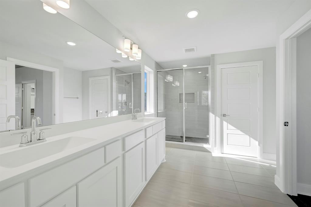 3501 Pineda Way McKinney, TX 75071 - Photo 37 of 40 a spacious bathroom with a double vanity sink mirror and next to a window