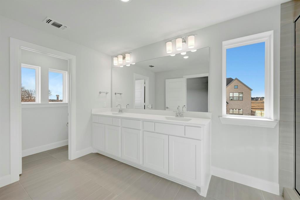 3501 Pineda Way McKinney, TX 75071 - Photo 38 of 40 a bathroom with double vanity sink and a mirror