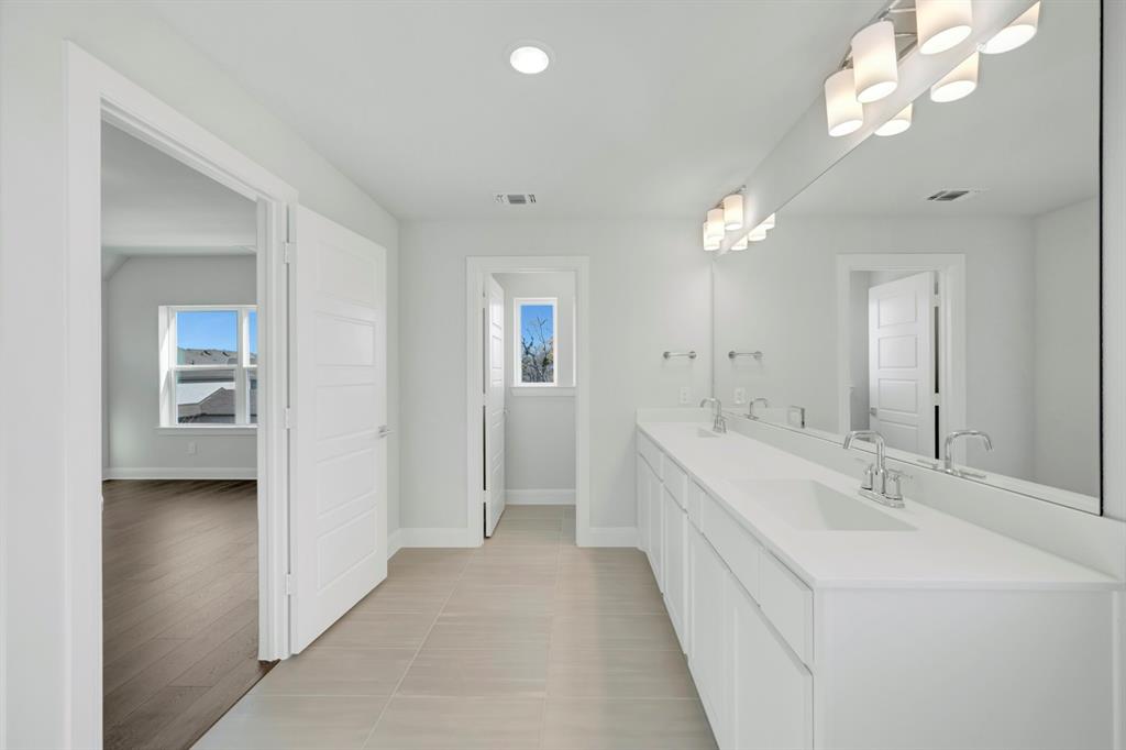 3501 Pineda Way McKinney, TX 75071 - Photo 40 of 40 a en suite bathroom with a double vanity sink and a mirror