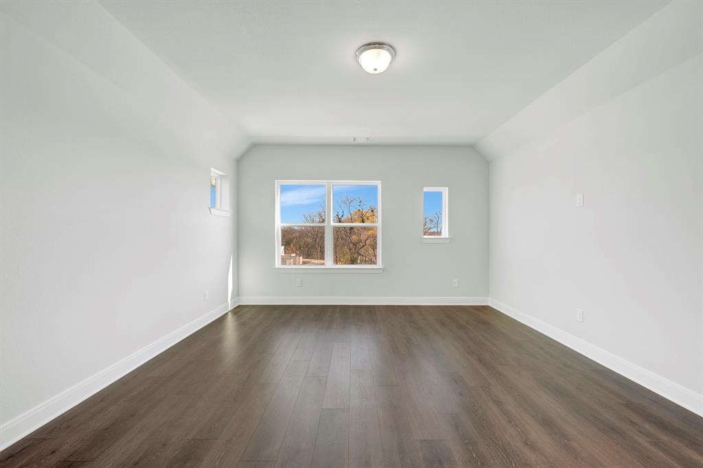 3501 Pineda Way McKinney, TX 75071 - Photo 4 of 40 an empty room with wooden floor and windows