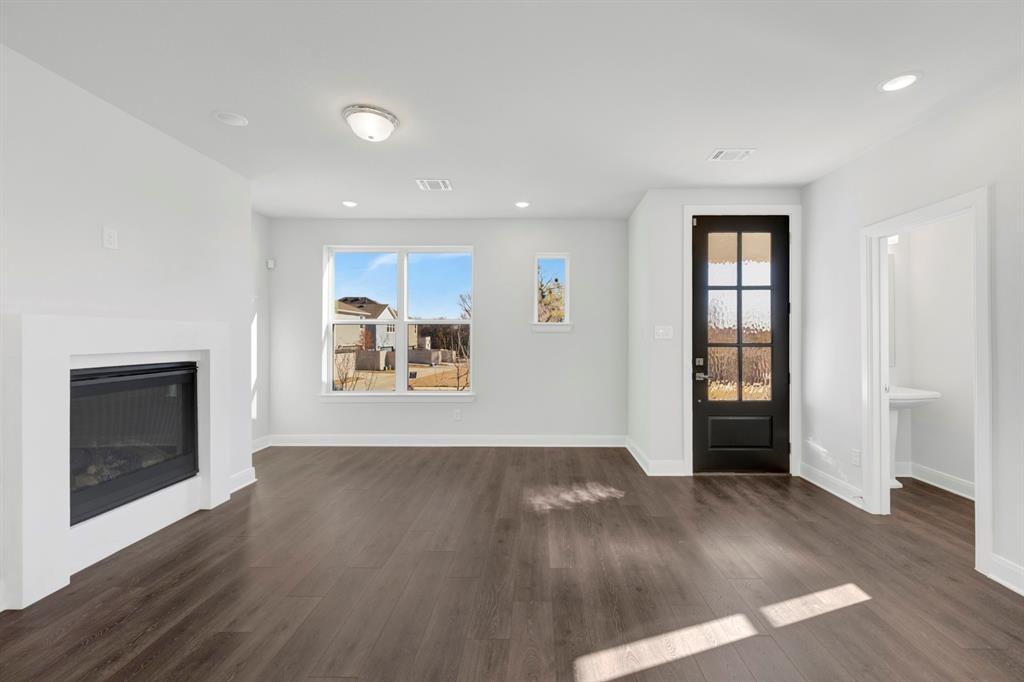 3501 Pineda Way McKinney, TX 75071 - Photo 8 of 40 an empty room with wooden floor and windows