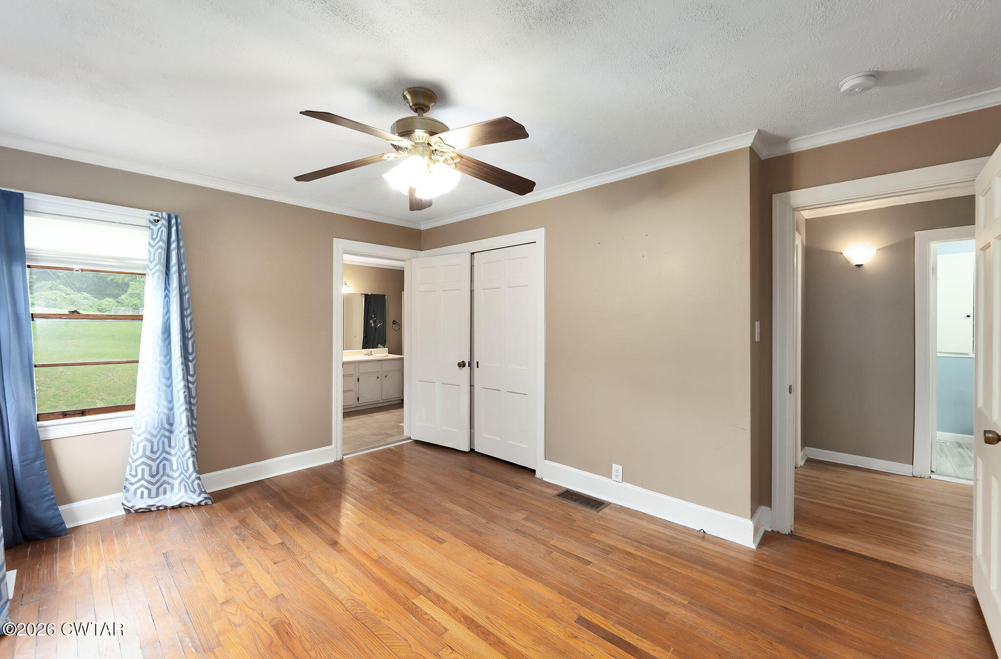 118 Radio Road Jackson, TN 38301 - Photo 14 of 22 a view of an empty room with wooden floor and a window