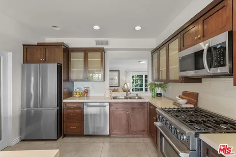 a kitchen with stainless steel appliances a refrigerator stove and sink