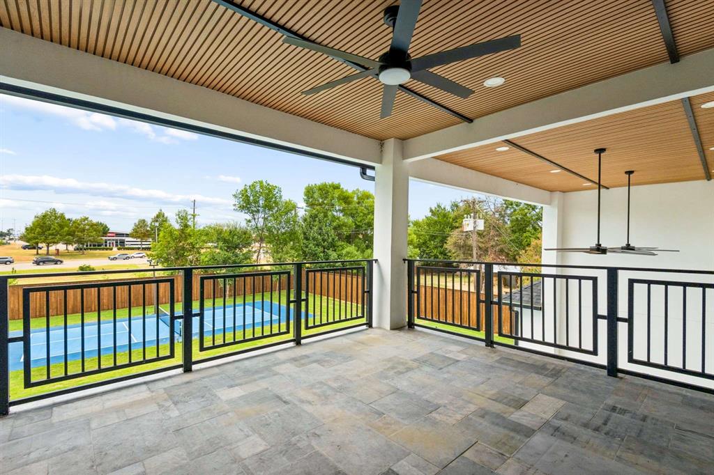 6606 Curtis Road Colleyville, TX 76034 - Photo 30 of 39 Expansive balcony featuring a textured tile floor, wood-slat ceiling, recessed lighting, and black ceiling fans