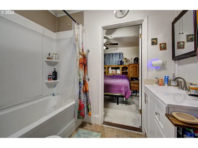 a bathroom with a tub sink and mirror