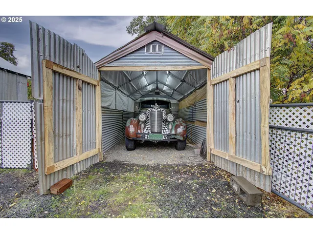 a view of a house with wooden deck and furniture
