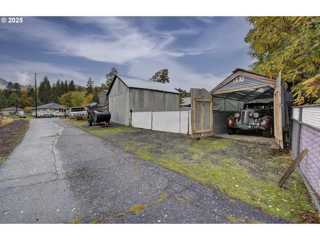a view of a house with a patio and a yard