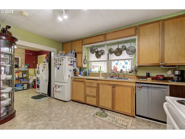 a kitchen with refrigerator and window