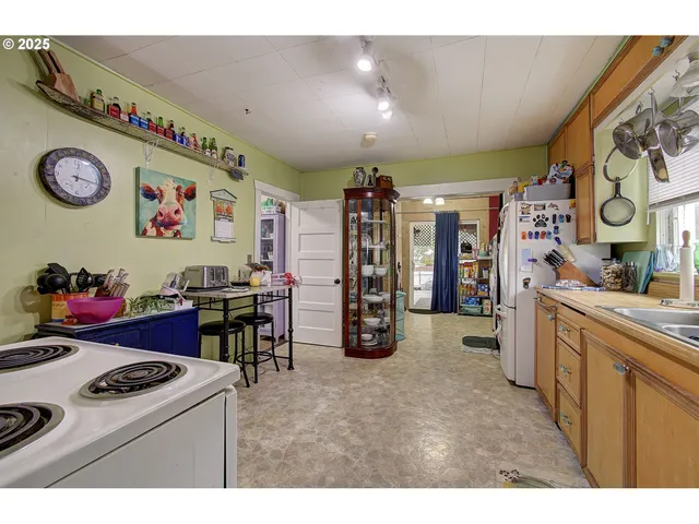 a view of a kitchen with fridge and a sink