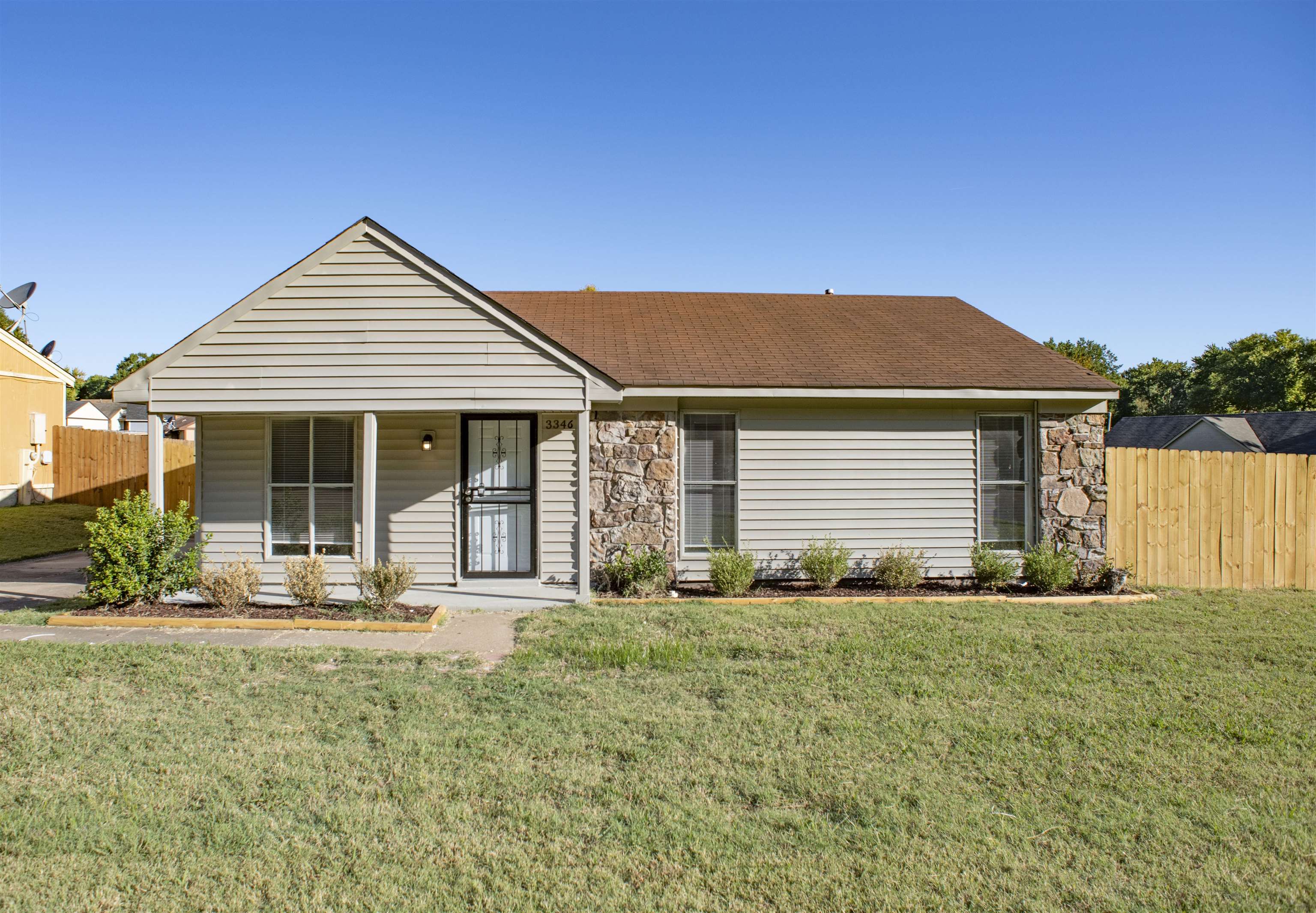 3346 Ridgemont Road Memphis, TN 38128 - Photo 1 of 12 a front view of a house with a garden
