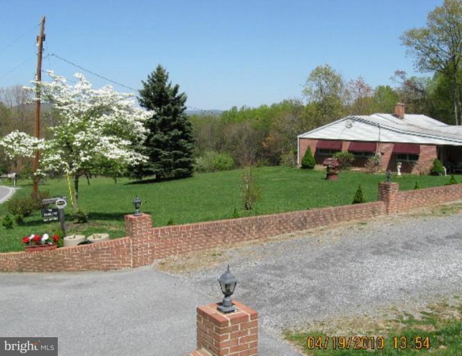 6541 Washington Monument Road Middletown, MD 21769 - Photo 1 of 7 a front view of a house with garden