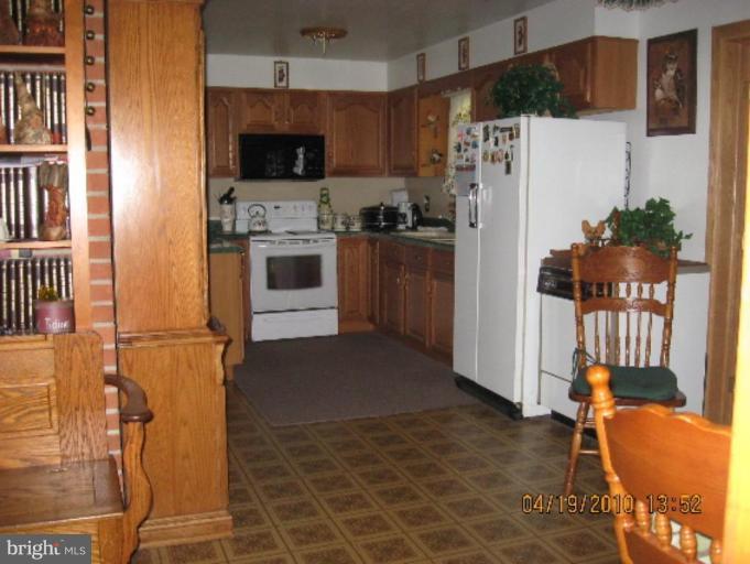 6541 Washington Monument Road Middletown, MD 21769 - Photo 4 of 7 a kitchen with stainless steel appliances a refrigerator and a stove top oven