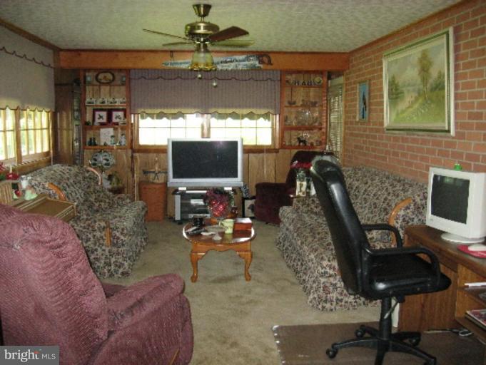 6541 Washington Monument Road Middletown, MD 21769 - Photo 7 of 7 a living room with furniture and a flat screen tv