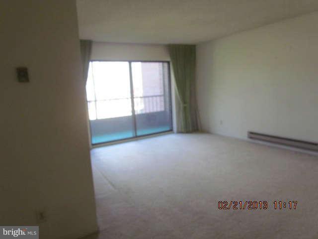 15311 Beaverbrook Court, Unit 902G Silver Spring, MD 20906 - Photo 2 of 10 a view of an empty room with a window
