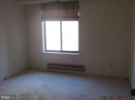 15311 Beaverbrook Court, Unit 902G Silver Spring, MD 20906 - Photo 7 of 10 an empty room with a window