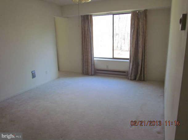 15311 Beaverbrook Court, Unit 902G Silver Spring, MD 20906 - Photo 10 of 10 an empty room with windows
