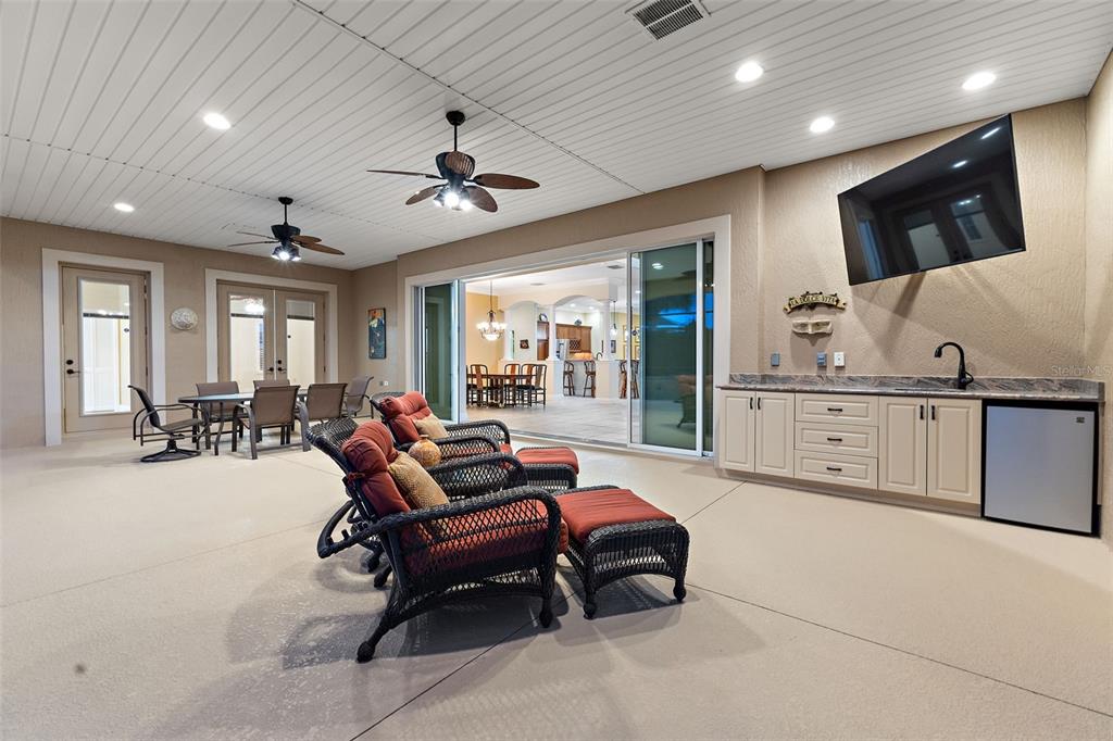 1850 Lake Ridge Drive The Villages, FL 32162 - Photo 17 of 70 a living room with furniture a flat screen tv and a large window