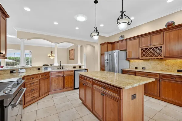 a large kitchen with cabinets and stainless steel appliances
