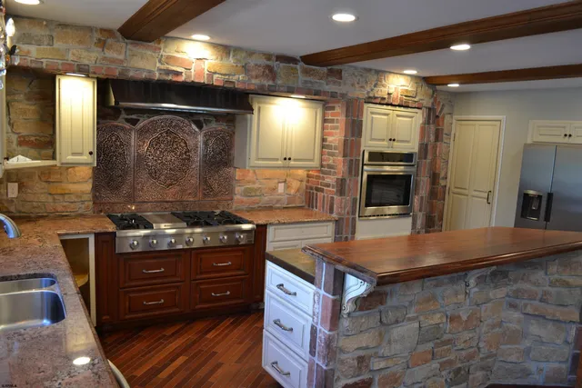a kitchen with a stove and a refrigerator