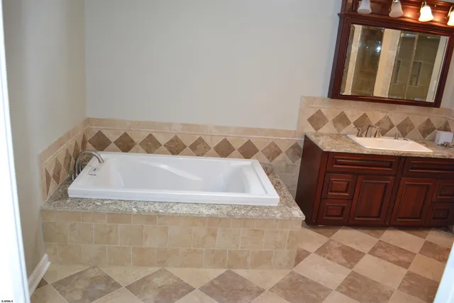 a bathroom with a bathtub and a sink