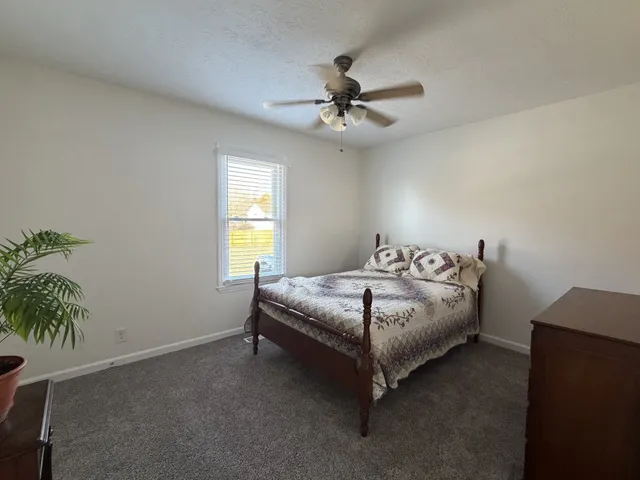 a bedroom with a bed and a potted plant