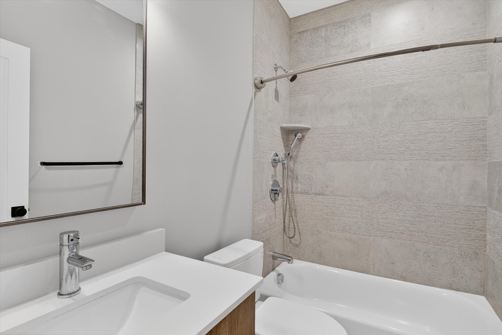 54 River Street, Unit 2 Boston, MA 02126 - Photo 13 of 16 a bathroom with a sink toilet and shower