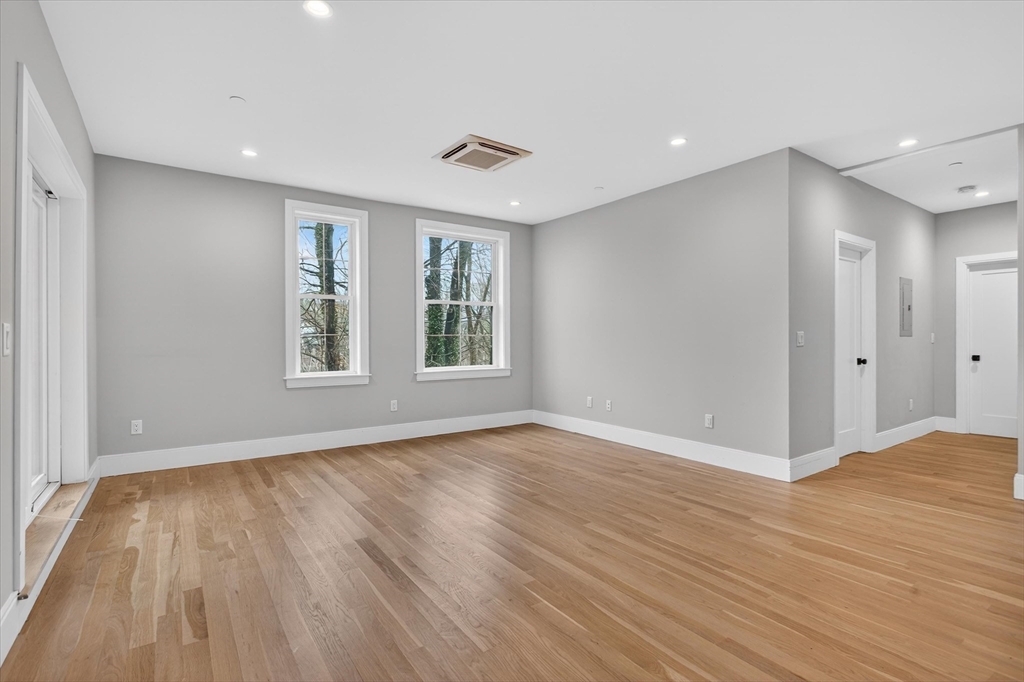 54 River Street, Unit 2 Boston, MA 02126 - Photo 7 of 16 a view of an empty room with wooden floor and window