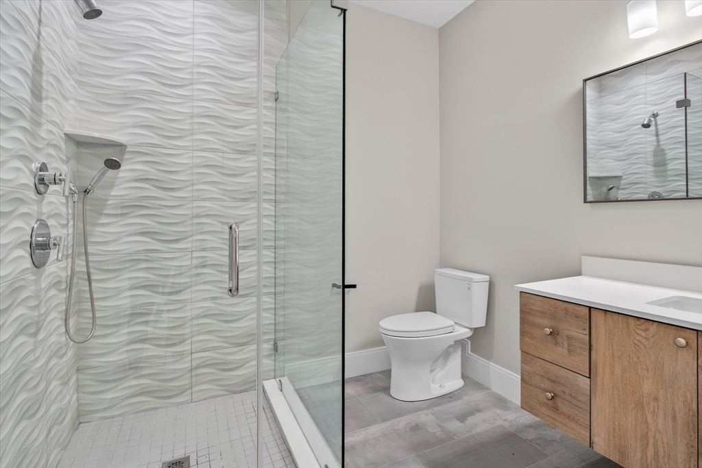 54 River Street, Unit 2 Boston, MA 02126 - Photo 10 of 16 a bathroom with a toilet sink and shower