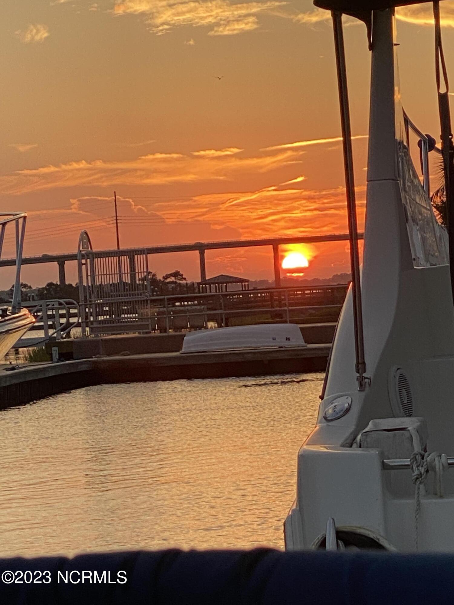 5202 Windlass Road Southport, NC 28461 - Photo 55 of 58 Sunset over the Oak Island Beach Bridge from Southport Marina
