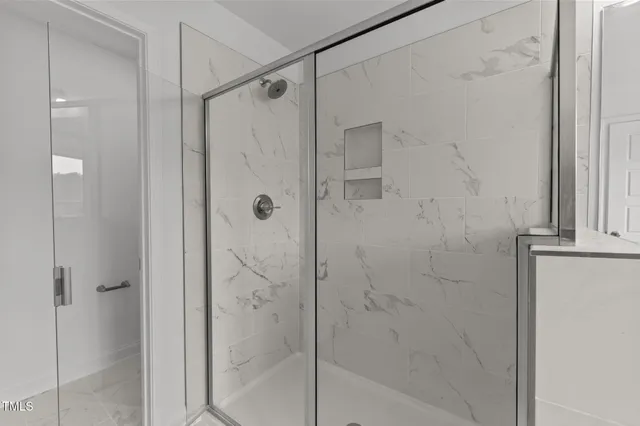 a bathroom with a glass shower door