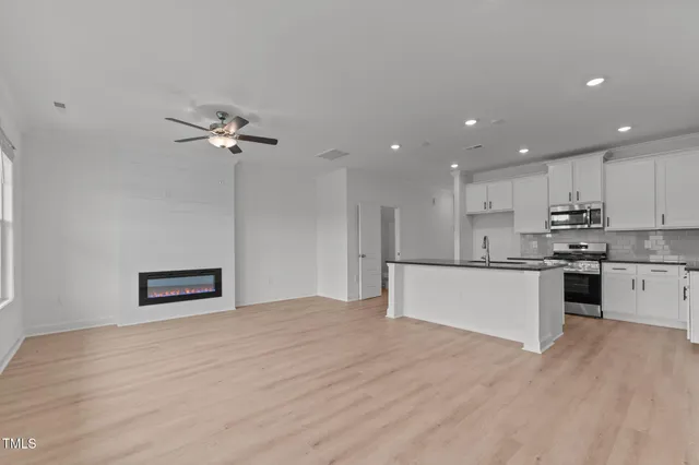 a kitchen with a refrigerator and a sink