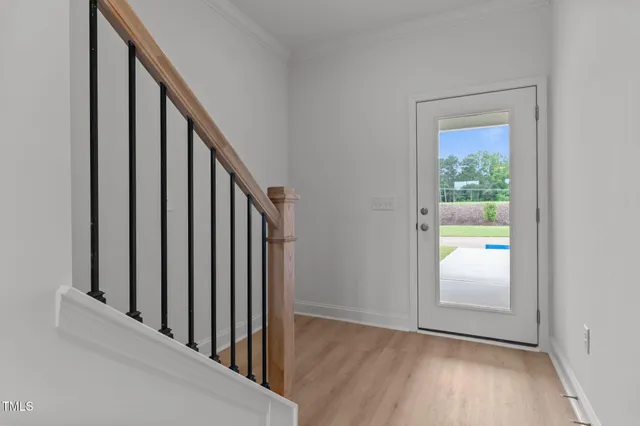 a view of a hallway view with wooden floor and staircase