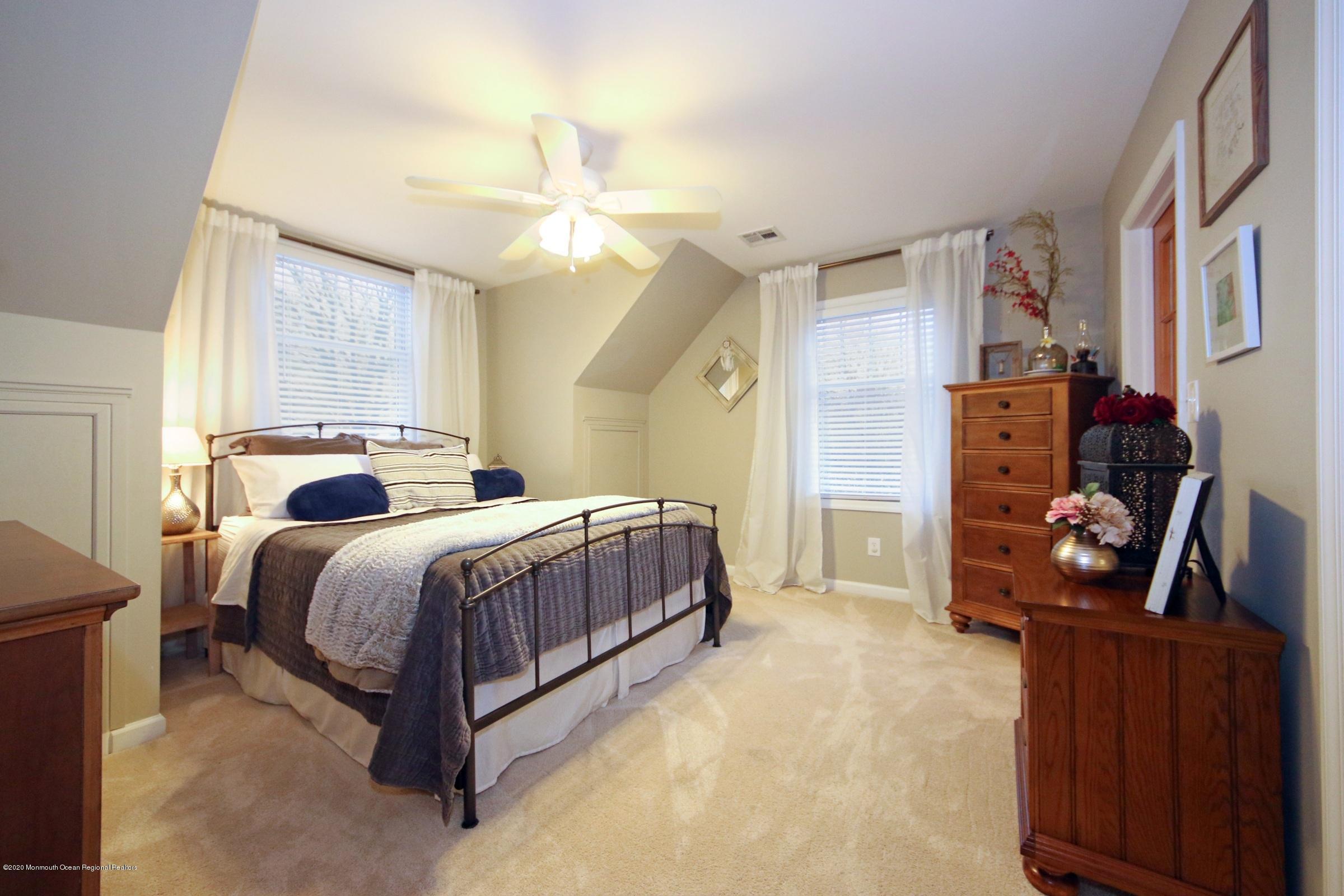 600 E Road Middletown, NJ 07748 - Photo 11 of 23 a bedroom with a bed and wooden floor