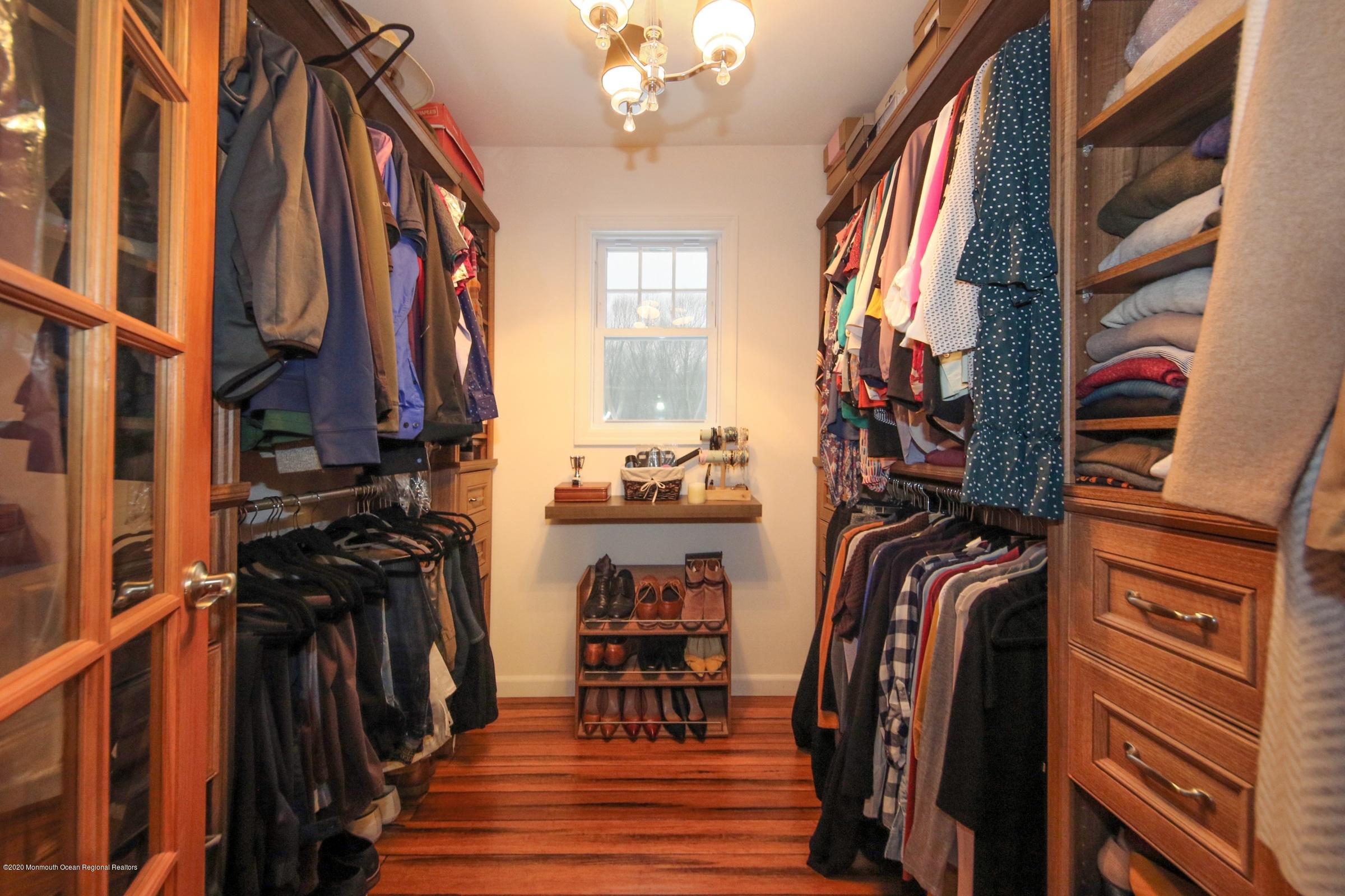 600 E Road Middletown, NJ 07748 - Photo 12 of 23 a view of walk in closet with clothes and shoes