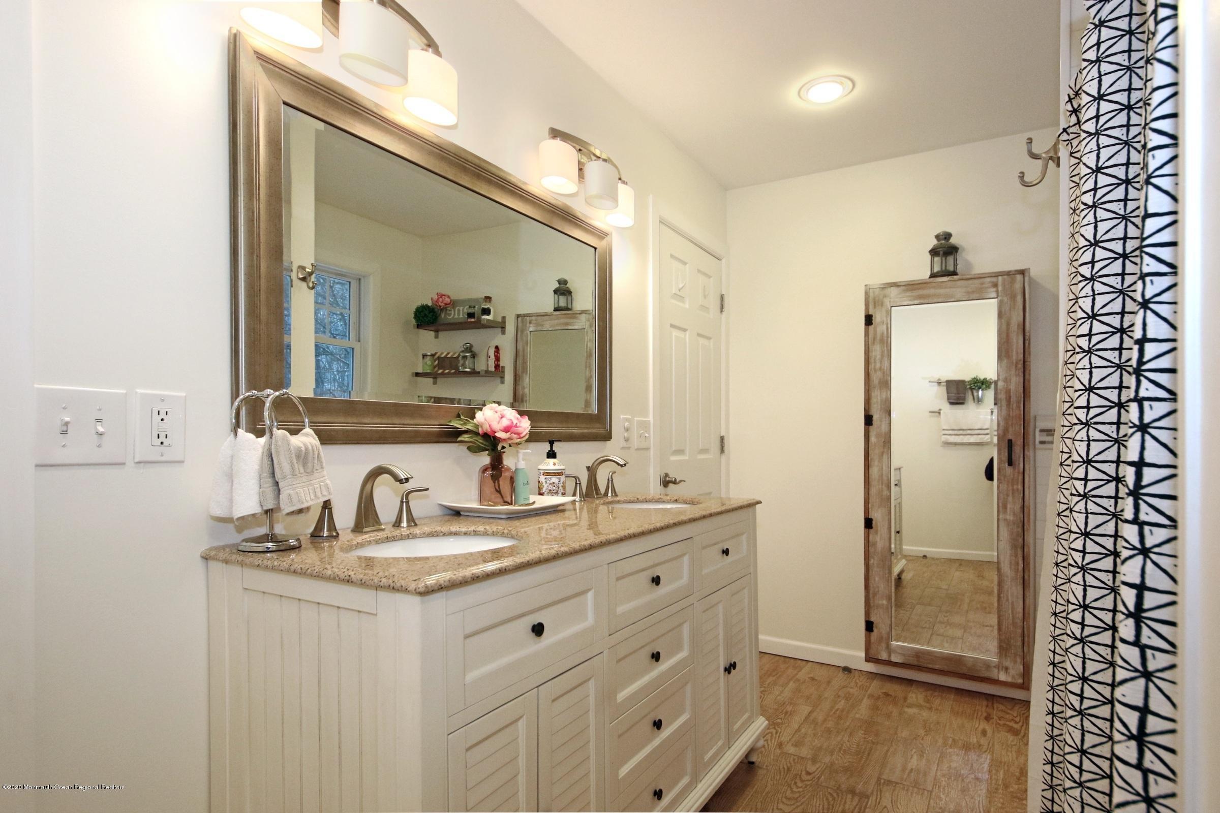 600 E Road Middletown, NJ 07748 - Photo 17 of 23 a bathroom with a double vanity sink and mirror