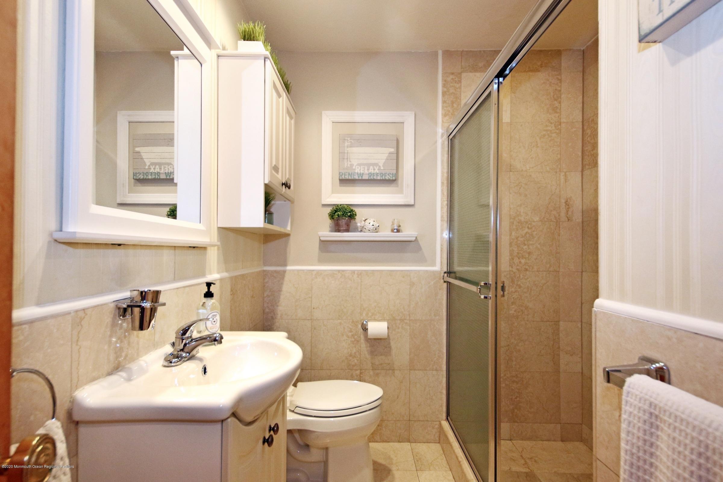 600 E Road Middletown, NJ 07748 - Photo 19 of 23 a bathroom with a sink toilet and shower