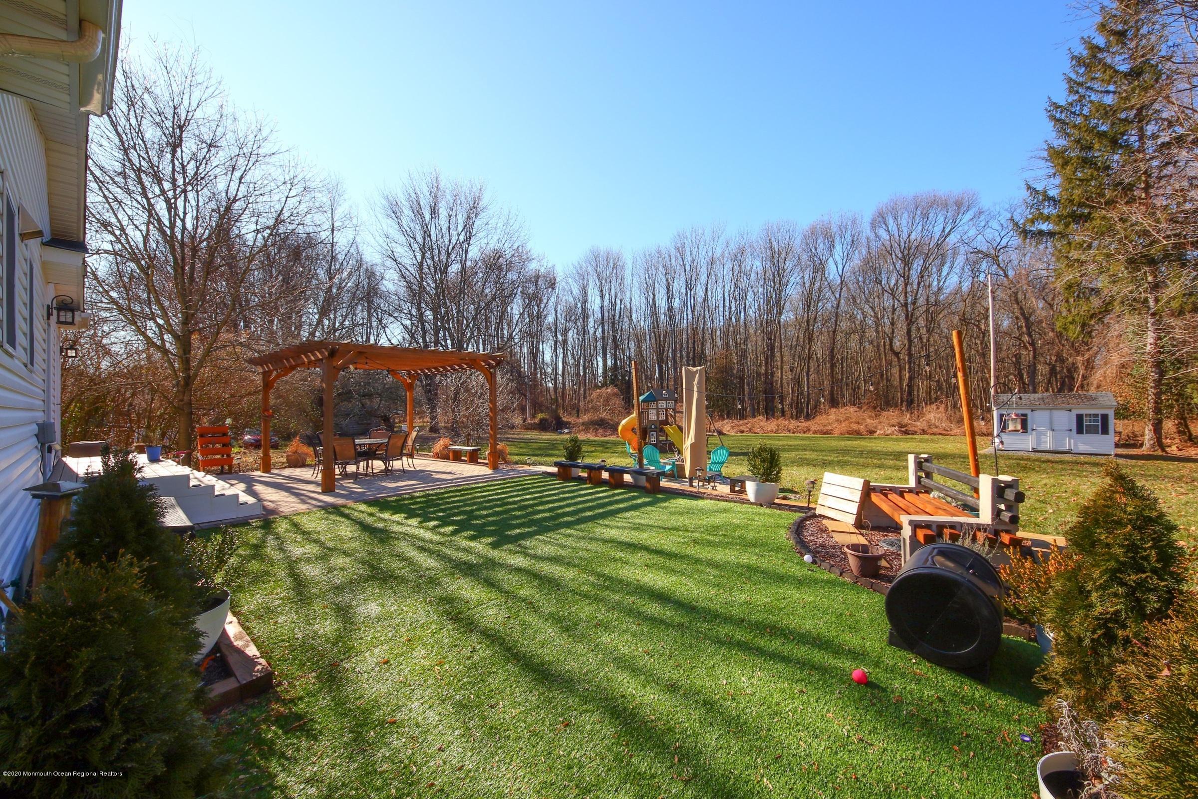 600 E Road Middletown, NJ 07748 - Photo 20 of 23 a view of a golf course with chairs and a fire pit