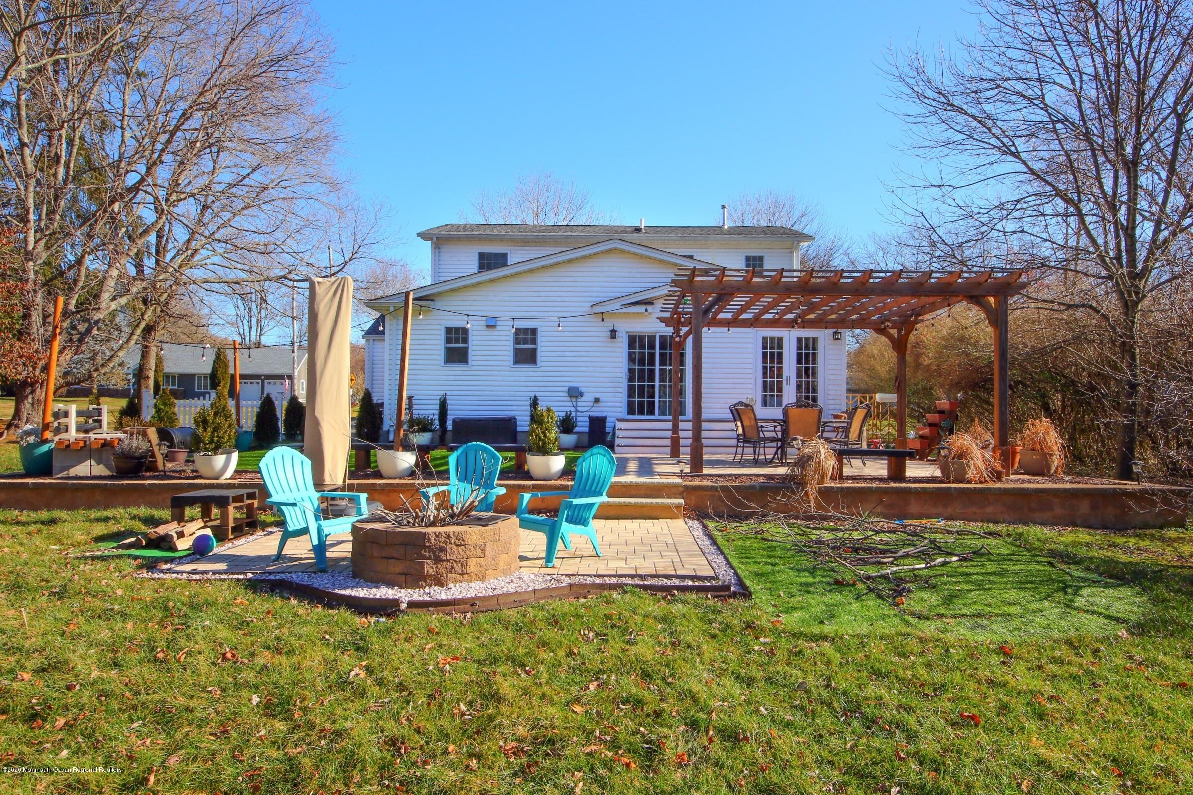 600 E Road Middletown, NJ 07748 - Photo 21 of 23 a view of a house with a swimming pool and sitting area