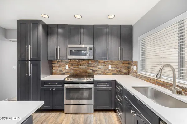 a kitchen with a sink stove and refrigerator
