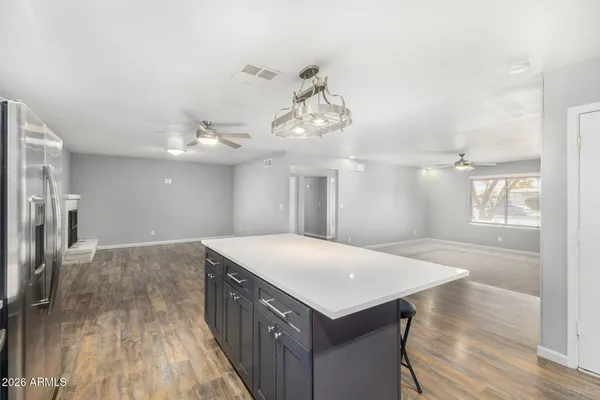 a kitchen with a wooden floor and window