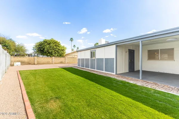 a view of a house with swimming pool and a yard