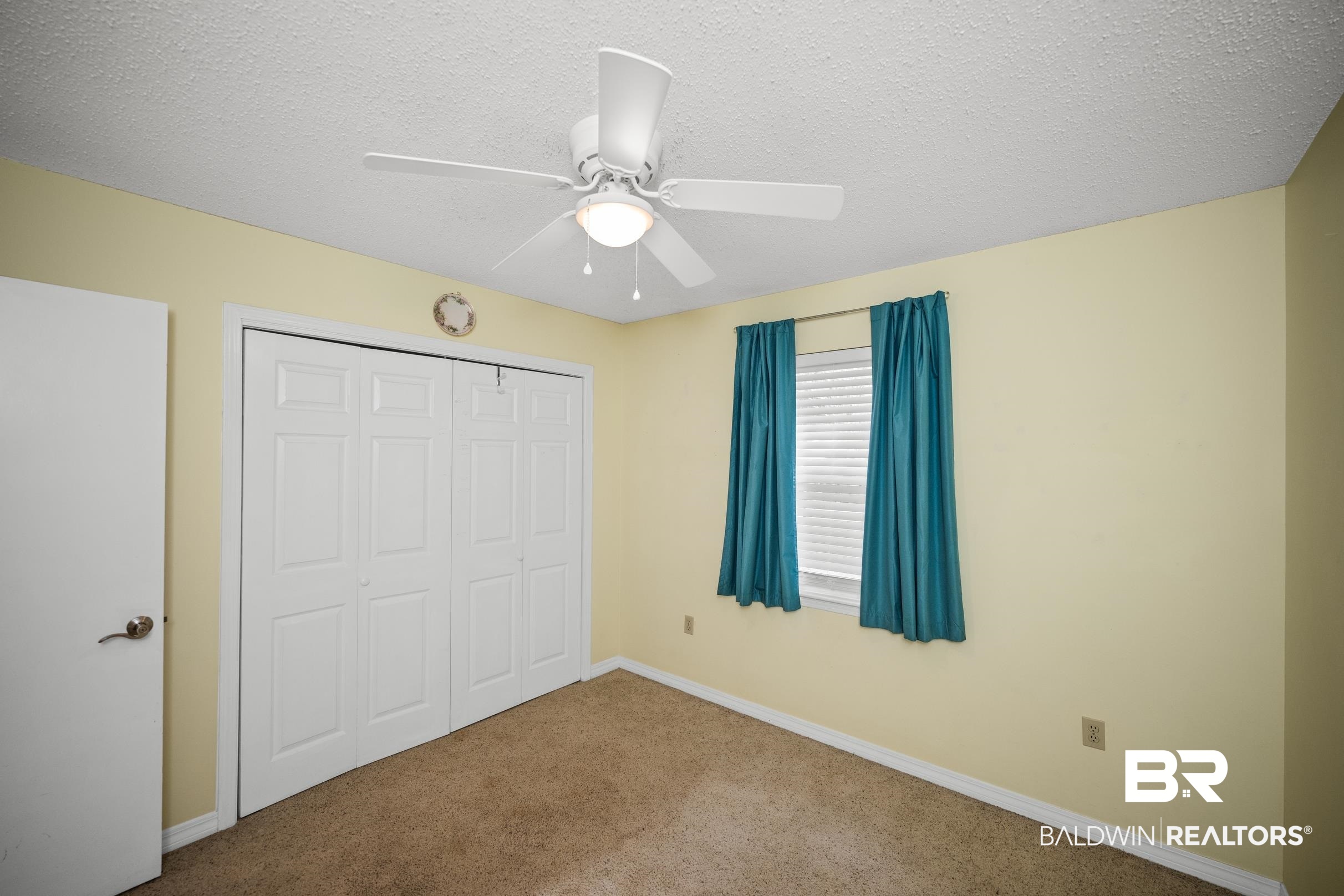123 Dunbar Loop Daphne, AL 36526 - Photo 20 of 33 Unfurnished bedroom featuring a textured ceiling, carpet floors, a closet, and a ceiling fan