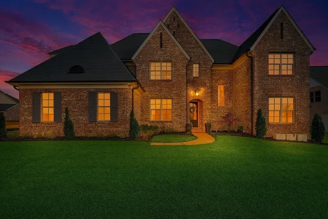 a front view of a house with a yard