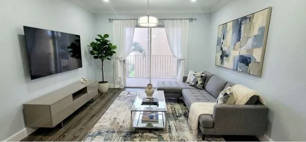 a living room with furniture and a flat screen tv