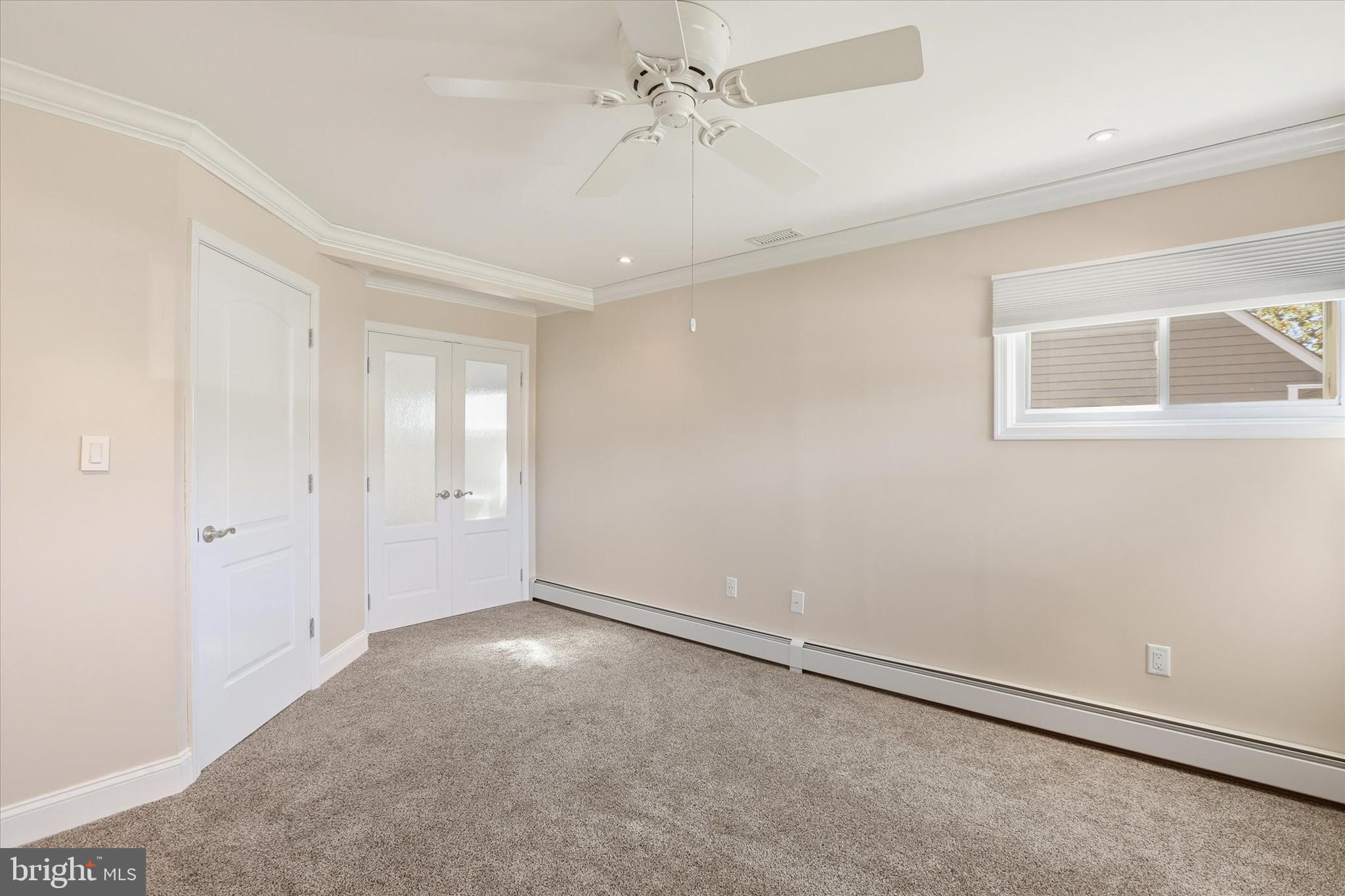 38 Violet Road Levittown, PA 19057 - Photo 17 of 29 an empty room with a ceiling fan and a window