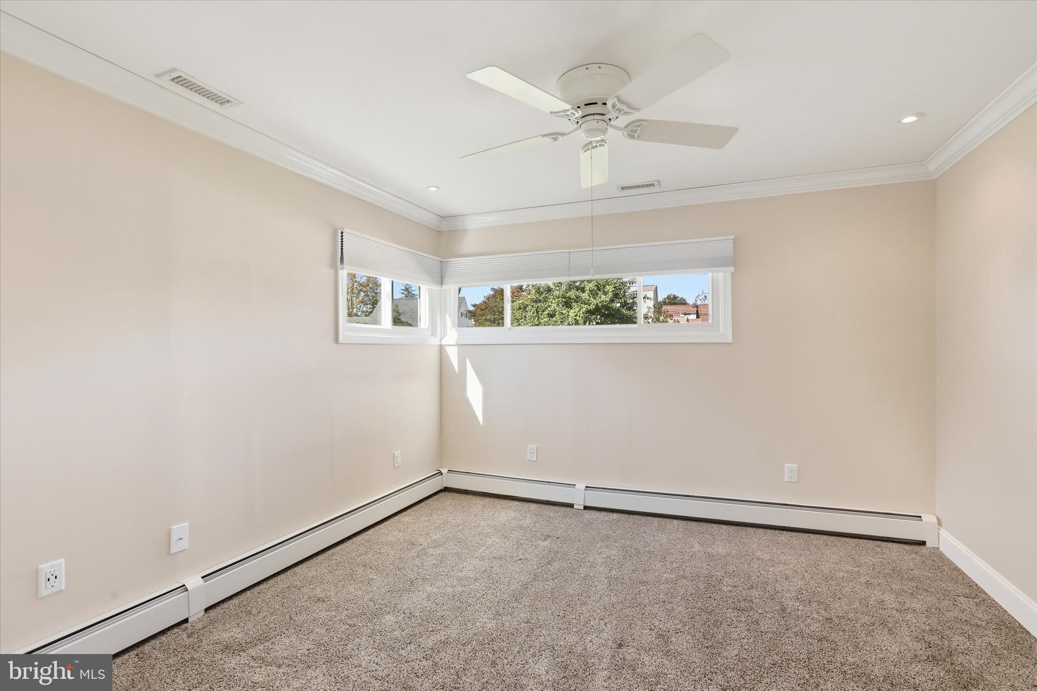 38 Violet Road Levittown, PA 19057 - Photo 18 of 29 an empty room with a ceiling fan and a window