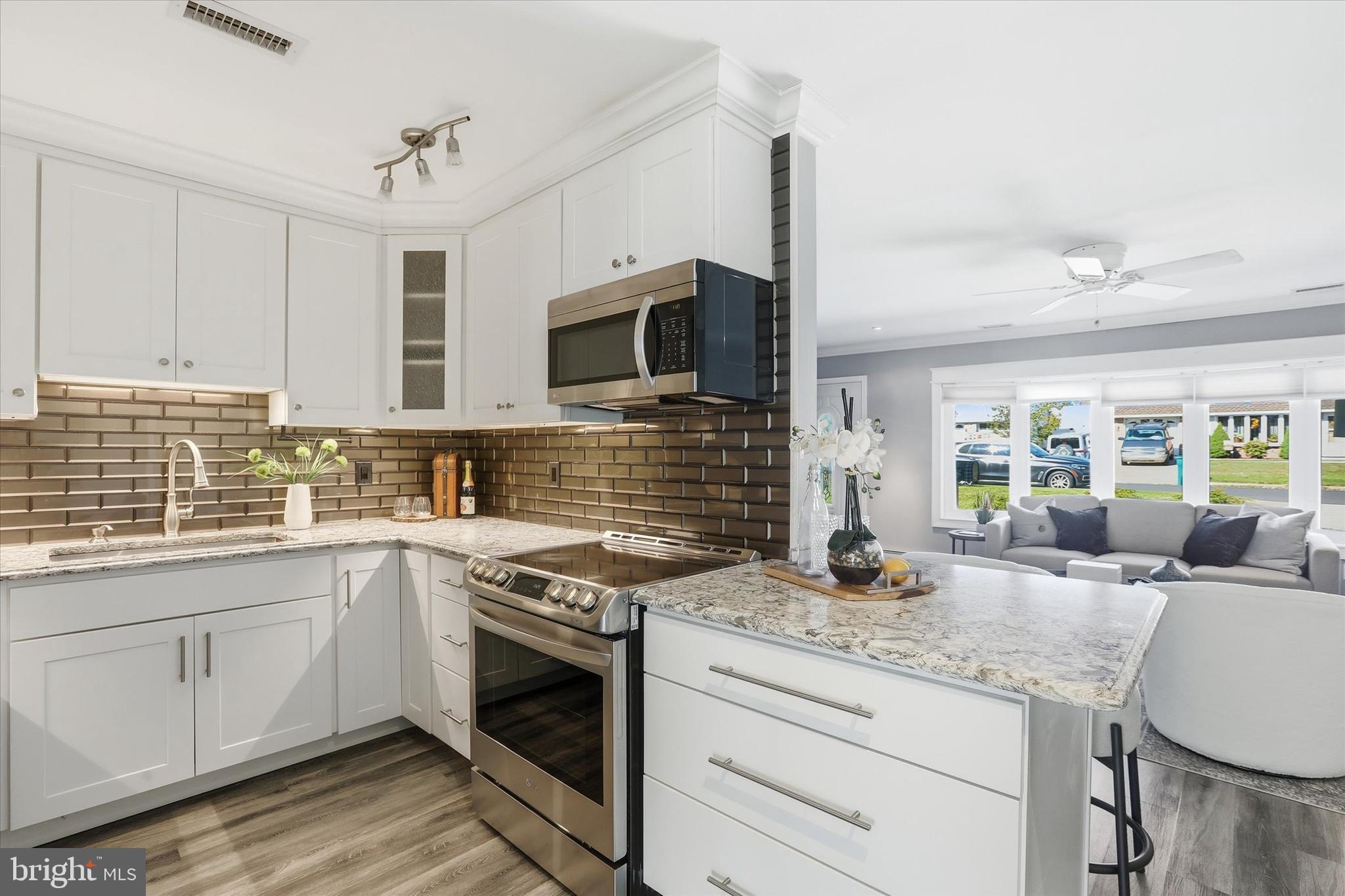 38 Violet Road Levittown, PA 19057 - Photo 8 of 29 a kitchen with granite countertop a sink stainless steel appliances and cabinets