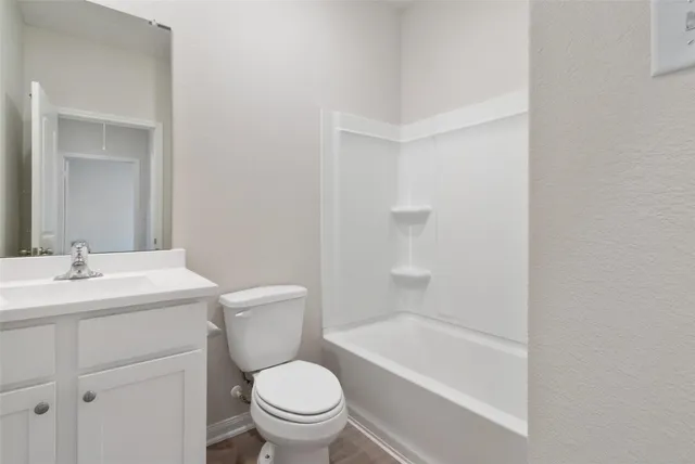 a bathroom with a sink toilet vanity and shower